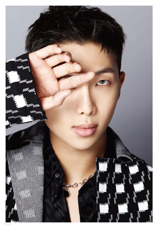A collection of black and white portraits of BTS's members in various poses 