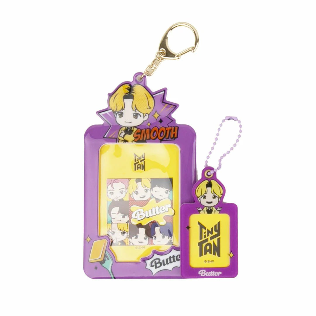 Keychain with cartoon character on a purple card against a white background