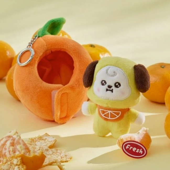 BTS BT21 Chimmy Plush toy in an orange shaped costume with a keychain and oranges on a light background