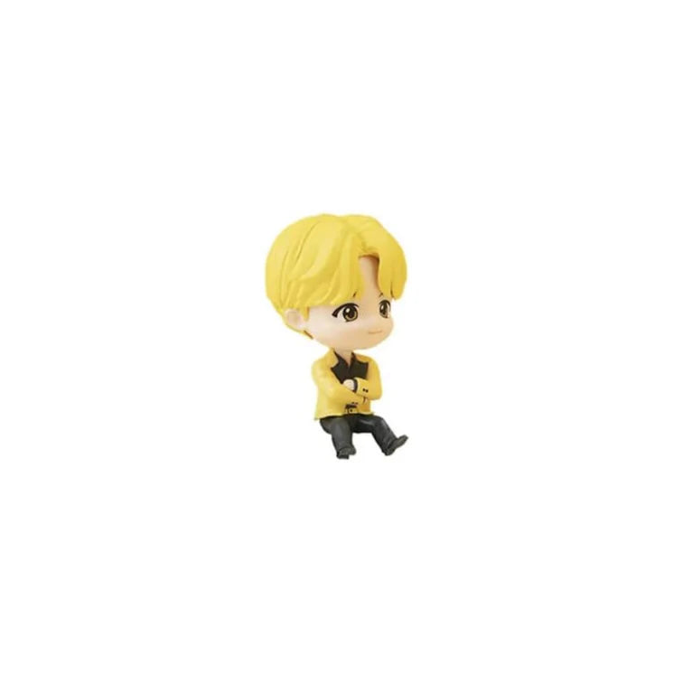 Small BTS TinyTAN J-Hope figurine with blonde hair and a yellow outfit on a white background