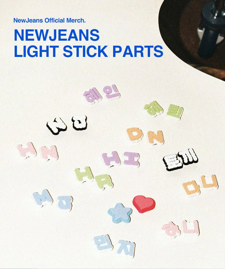 Collection of colorful light stick parts with text and symbols on a white background, labeled as NewJeans Official Merchandise.