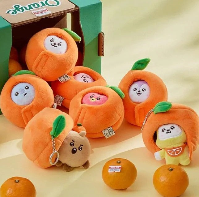 BTS BT21 Plush toys shaped like oranges with cute faces on a beige background