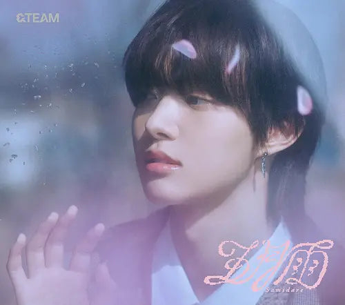 &Team member EJ with a blurred background and soft lighting with flower petals in his hair for Samidare album CD