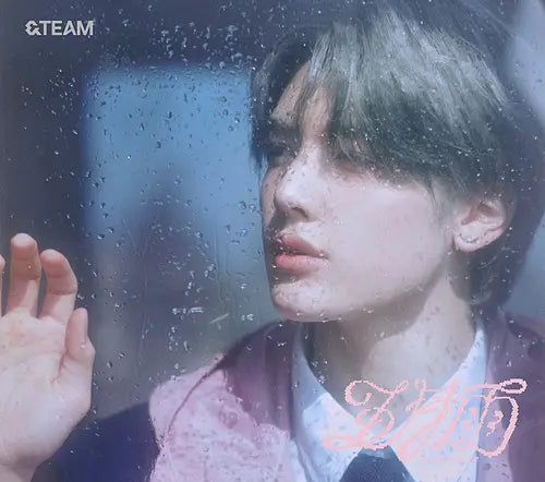 &Team member Maki looking out of a rain-covered window with a blurred background for Samidare album CD