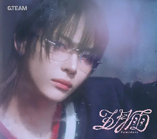 &Team member Nicholas wearing glasses with a blurred background for Samidare album CD